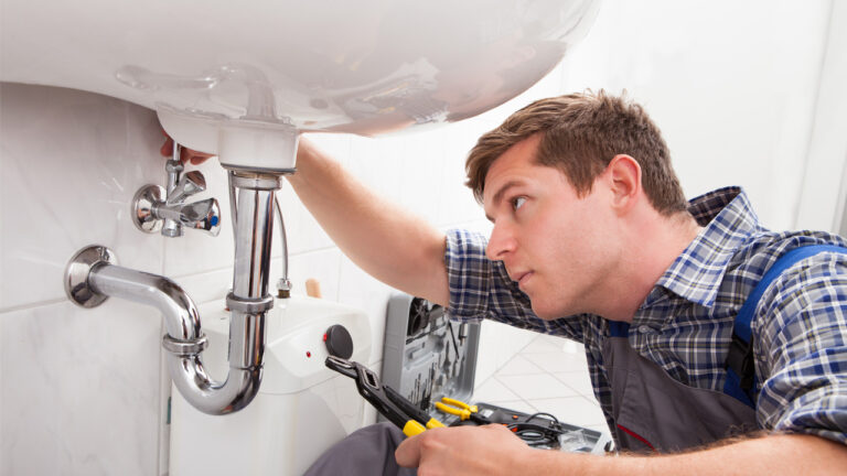 employee working on plumbing pipes